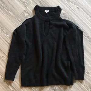 Black sweater with shoulder cutouts.